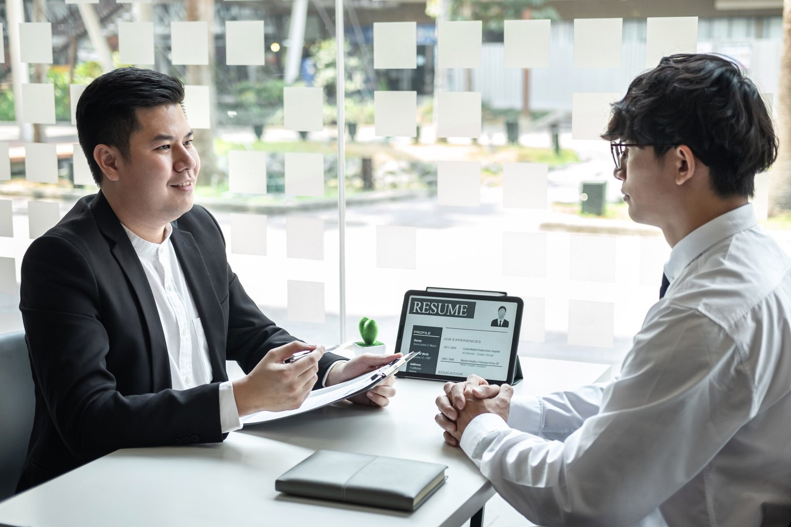 Businessman interview consider a resume conversation during about profile of candidate of conducting a job interview listen to answers while sitting at the working meeting in office.