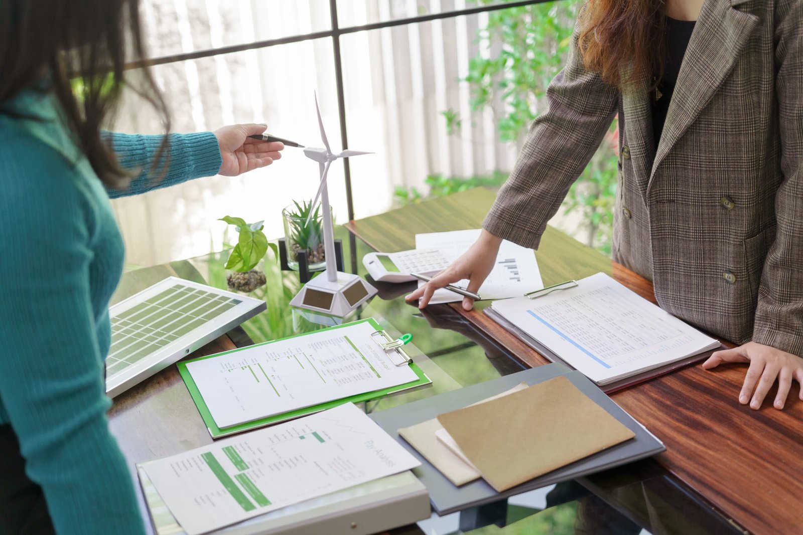 Solar panels green energy Business people working in green eco friendly office business meeting creative ideas for business eco friendly professional teaching corporate people sustainable electricity.